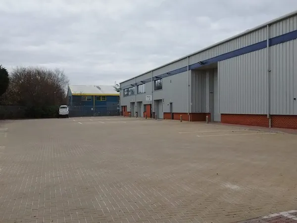 Block paved car park at an industrial unit after pressure washing, moss and grime gone