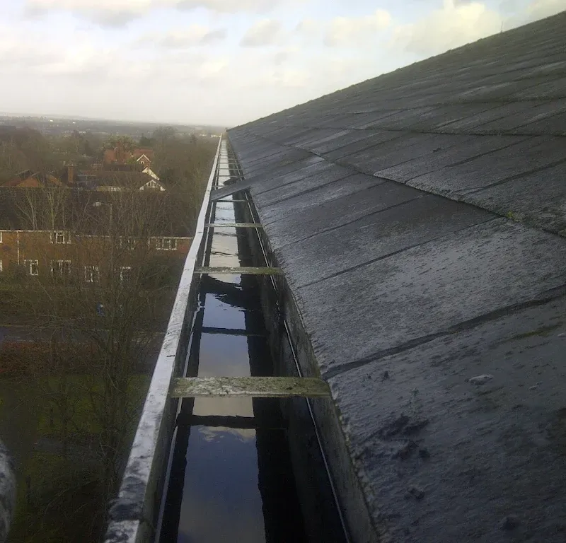 Powered access platform beside a building, with the Brilliant Window Cleaners van below