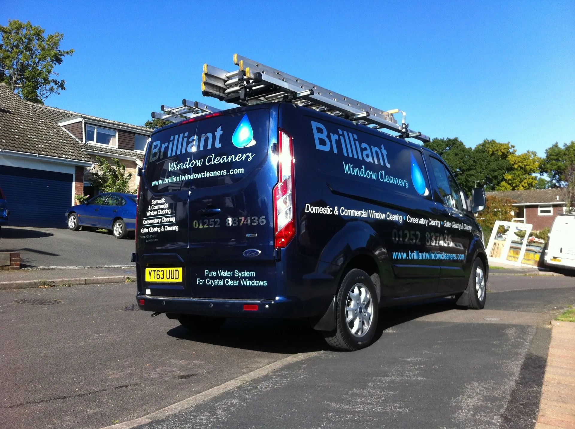 Window cleaner in Guildford: the Brilliant Window Cleaners van with its pure water pole system, ready for a round