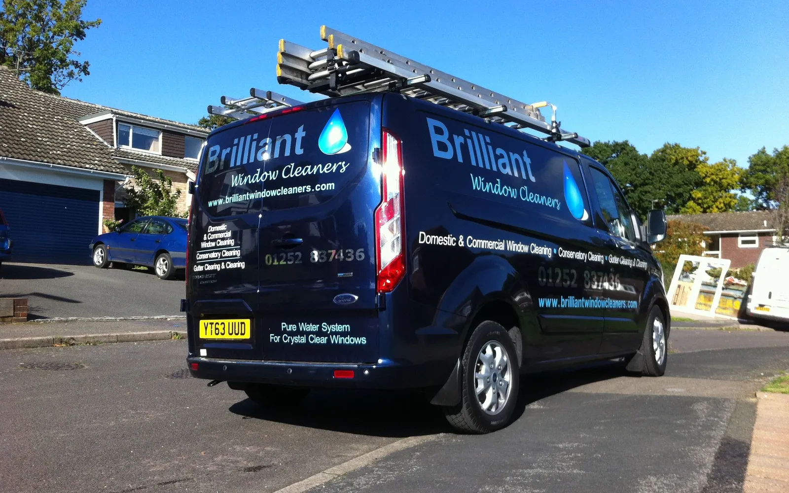 The Brilliant Window Cleaners navy Transit with ladders and the pure water system on board